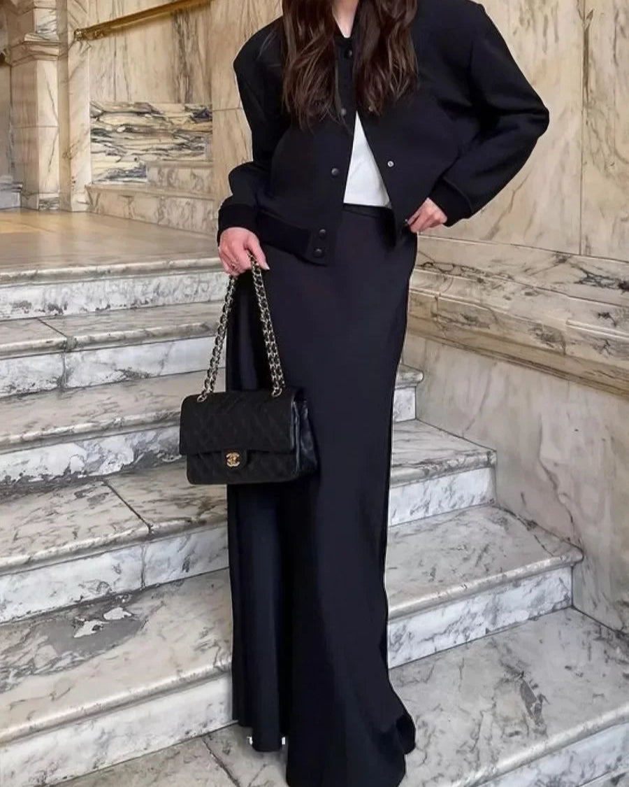 Jupe Anna noire, mi-mollet et style intemporel pour femme.